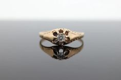 a diamond ring sitting on top of a table