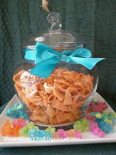 a glass jar filled with cereal on top of a white plate