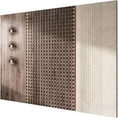 a metal wall with three knobs on each side and several holes in the middle