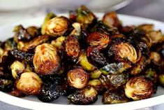 a white bowl filled with brussel sprouts on top of a table