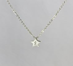 "A tiny star, hand stamped with personalized initial, sweet and cute. Or you can have the star without initial, the plain lucky star. Sterling silver star measures about 7 mm, with brushed finish. Leave a message in \"Note to Fabulouswire\" when you place your order if you choose to have an initial stamped. Customized sterling silver chain length can be selected from 12\" to 18\". All components are 925 sterling silver." More Precious Than Rubies, D Initial, Silver Initial Necklace, Ring Holder Necklace, Tiny Star, Anniversary Gift Ideas, Initial Pendant Necklace, Lucky Star, Initial Jewelry