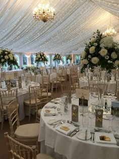 a banquet hall set up with tables and chairs