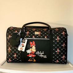 Nwt. Limited Edition Disney Minnie Mouse Travel Duffle Bag With Loads Of Space. Sturdy, Washable Pvc. Silver Metal Disney Zipper Pulls. Detachable Minnie Mouse Coin Purse. Detachable, Adjustable Cross Body Strap. Front Exterior Zippered Pocket Featuring Minnie Mouse Herself. Dual Carrying Handles With A 7 Inch Drop. Top Zip Entry With A Smooth Interior Lining And One Zippered Pocket. Measures Approximately 18 Inches Long, 11 Inches High And 8 Inches Wide. Included For Free: Nwt My Tagalongs Hair Black Minnie Mouse Travel Bag, Black Minnie Mouse Bag For Disney Trips, Cute Minnie Mouse Travel Bag, Black Mickey Mouse Travel Bag, Cute Mickey Mouse Bags For Travel, Disney Style Minnie Mouse Bag For Disney Trips, Minnie Mouse Bags For Disney Trips, Disney Style Minnie Mouse Bag For Disney Fan Events, Disney Minnie Mouse Bag For Disney Fan Events