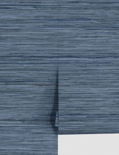 the blue and white wallpaper is made up of thin strips of fabric that are woven together