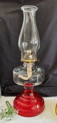 a glass oil lamp sitting on top of a table