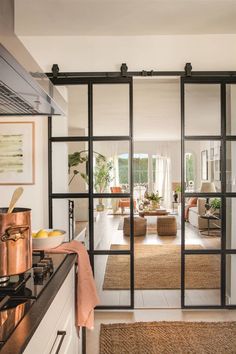 an open kitchen and living room with sliding glass doors