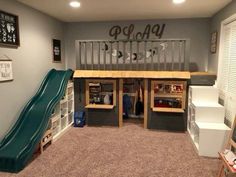 a room with a slide, bookshelf and play area