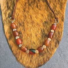 This Is An Artisan Made Necklace With Adjustable Length. Brown Leather Suede Tie Close That Is Double Strand And Where It Is Tied Now, Measures At An 18" Necklace But Can Go Longer. Gemstones Are A Beautiful Deep Orange Agate And Glass That Is Frosted In White. Ooak, Great Statement Piece! Necklace Leather, Orange Agate, Leather Tie, Deep Orange, Glass Bead Necklace, Gemstone Colors, Womens Jewelry Necklace, Brown Leather, Glass Beads