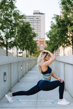 a woman is doing yoga outside on the sidewalk with her arms behind her head and legs crossed