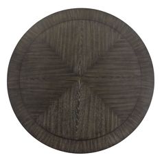 a round wooden table top with an intricate design on the center, and dark wood grained surface