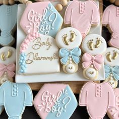 baby shower cookies are arranged on a table