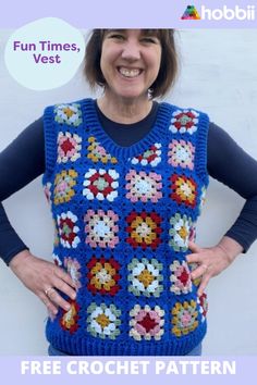 a woman standing in front of a white wall wearing a blue crocheted vest