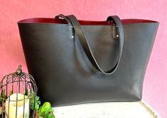 "All our bags are made to order. Production time is 3-5 business days, up to 7 days for custom orders. Black pebbled leather tote with red leather lining and front pocket. ❗️Measurements: ❗️ 24\" W(top opening ) 13\" H 17\" W base x 7\"D Strap drop 10\" Weight 3 lbs FUNCTIONALITY: * This bag is roomy and stylish, great for your weekend getaway, perfect for work and school, can hold your computer, books, files, change of clothes and your daily essentials. * Over the shoulder long leather straps t Red Leather Laptop Bag For Everyday Use, Computer Books, Work And Travel, Leather Tote Bags, Computer Bag, Red Interior, Black Leather Tote, Black Pebbles, Computer Bags