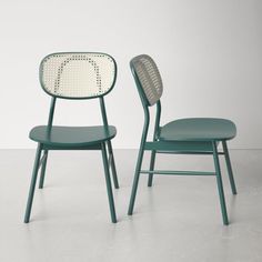 two green chairs sitting next to each other