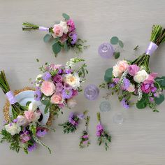 three bouquets of flowers are arranged on a table