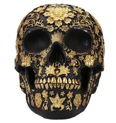 a black and gold skull with ornate designs on it's face, sitting in front of a white background