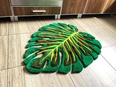 a green rug on the floor in a kitchen