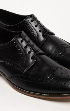 Our black derby brogue shoes fuse classic craftsmanship with contemporary style. Meticulously crafted from premium materials, these shoes boast a sleek black hue that is the epitome of sartorial excellence. The intricate brogue detailing adds a touch of timeless charm, elevating any look with subtle elegance. Subtle Elegance, Brogue Shoes, Derby, Contemporary Style, Sleek, Black