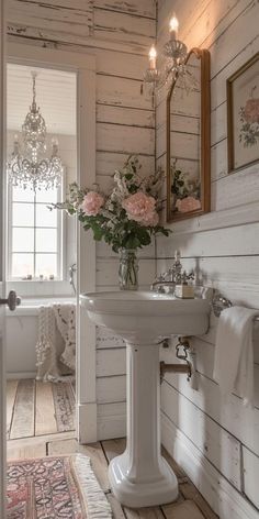 a white sink sitting under a mirror in a bathroom next to a rug and window