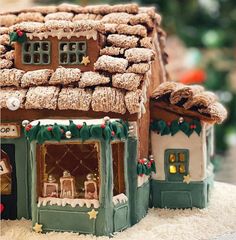 a gingerbread house decorated with icing and decorations