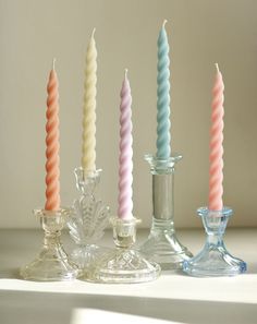 four candles are lined up next to each other