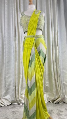 !! Designer Collection!! Beautiful neon green Pre pleated ready to wear 1 min saree with hand embroidered bead work blouse and belt. Pre drapped sari.Perfect outfit for Asian wedding ceremonies or festivals. It is very comfortable and light weight yet stylish and elegant. Details Blouse Fabric: Georgette Inner : Padded and Crepe lined Colour: green Sleeves: Sleeveless with additional cloth for sleeves Embroidery : sequins, beads hand embroidery  Saree Fabric: Chiffon and net Colour : lime green Silk Anarkali Saree With Draped Style, Green Georgette Draped Saree, Green Silk Pre-draped Saree, Anarkali Silk Saree, Green Pre-draped Saree For Wedding, Green Draped Saree With Unstitched Blouse, Anarkali Draped Saree For Festive Occasions, Traditional Green Draped Blouse Piece, Green Draped Lehenga With Cutdana