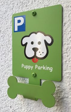 a green sign with a dog's face on it that says puppy parking