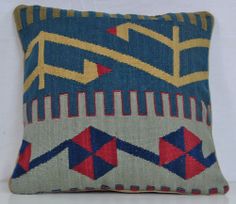 a blue and yellow pillow with geometric designs