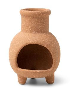 a clay vase with a hole in the middle on a white background, it appears to be made out of clay