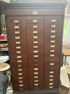 an old wooden filing cabinet with many drawers