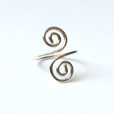 "This silver spiral ring is handmade with solid Sterling Silver. A classic and timeless design that looks fabulous with everything, and is comfortable to wear every day. Please select your size when ordering. Sizes are listed in UK/Australia format, but you can give your measurement in millimetres or in international sizes, whatever is easiest for you. Select \"Other Size\" from the bottom of the list, then add a note in the \"message to seller\" box at checkout. ❀ Made with 935 Sterling Silver, Minimalist Sterling Silver Spiral Ring, Minimalist Spiral Sterling Silver Ring, Adjustable Spiral Ring With A Modern Twist, Silver Spiral Wire Wrapped Rings, Adjustable Spiral Midi Rings In Silver, Adjustable Spiral Silver Midi Rings, Silver Spiral Midi Rings As Gift, Adjustable Silver Spiral Midi Rings, Nickel-free Spiral Silver Rings