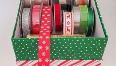 a box filled with lots of different types of christmas ribbons and ribbon on top of each other