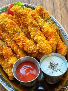 fried food on a plate with dipping sauces