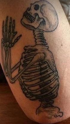 a skeleton tattoo on the leg of a person