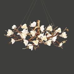 a chandelier with white flowers hanging from it