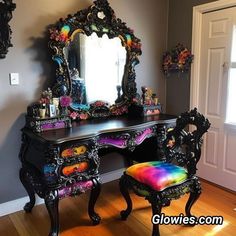 an ornate desk with a colorful chair and mirror in the corner on top of it