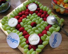 grapes and strawberries arranged in the shape of a heart with yogurt on top