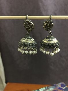 "I have accented a pair of unique Jhumkas with freshwater pearls. These are super cute with a bit of etched work on them. The Peacock ear wires add more drama. These are light weight and won't pull on your ears. If you are new to Jhumkas I would highly recommend this pair. You will love this pair. Pair it with any outfit you can dream of to your favorite Indian Restaurant.    TOTAL Length - 1.25\". Please feel free to ask me for more pictures or questions. Thank You for Shopping Jhumkas they are Ancient, Elegant, Opulent and Regal!l" Traditional Intricate Dangle Jhumkas, Traditional Cutdana Dangle Jhumkas, Traditional Cutdana Jhumkas Dangle, Traditional Cutdana Jhumkas, Traditional Round Jhumkas With Latkans, Elegant Navratri Jhumkas, Cutdana Dangle Jhumkas For Celebrations, Elegant Festive Jhumkas With Peacock Design, Festive Pearl Drop Earrings In Metal