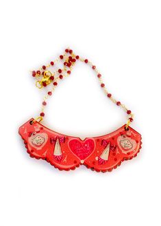 ' oh la la french Paris collar necklace' Please welcome our oh la la necklace with rosary beads! perfectly can be worn over a shirt because this baby works as a collar too! get your frilly lilly on and look simply delicious  with this unusual piece. Necklace basics * Measurements - 7cm x 5cm bib.. 18 inch rosary ruby red chain from Italy. * Illustrated piece featuring french shoes and perfume bottles. * Big love heart stating 'Paris mon amore'  * Rosary style beads with gold plated lobster clasp Cute Red Necklace For Parties, Cute Necklaces For Valentine's Day Party, Handmade Pink Bib Necklace As A Gift, Handmade Pink Bib Necklace For Gifts, Cute Necklaces For Mother's Day Party, Cute Valentine's Day Party Necklaces, Rosary Bead Necklace, Frilly Collar, French Shoes