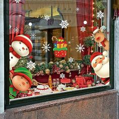 a store window decorated with christmas decorations and snowmen