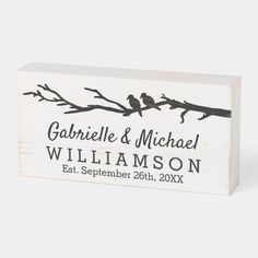 a wooden block with two birds sitting on it's branch and the words, gobblel & michael william