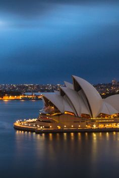 the sydney opera house lit up at night