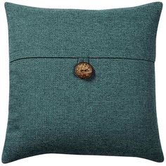 a green pillow with a wooden button on it