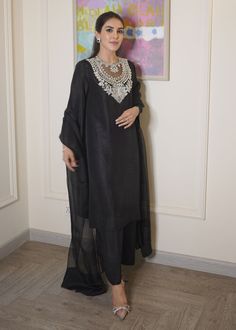 Black raw silk dress has beautiful sequin and cutdana embroidery over the neck, paired with orgenza dupatta. This dress is fully lined. ✨ You can wear this super stylish dress in any of your party, office and gathering ✨This dress can be customise in any other colour and in all size also ,please contact us regarding any changes if you want.We will make this dress as per your choice. ✨We take little longer time to manufacture as we take lot of care while manufacturing the outfit. So that our customers get fully satisfied when they receive the dress. Your patience is important ✨There may be slight colour difference due to high quality camera resolution and other filters. Rest everything will be same.  🌸Care instructions Dry clean only Long Sleeve Organza Salwar Kameez With Mirror Work, Chanderi Dabka Palazzo Set For Party, Tissue Silk Long Sleeve Sharara For Party, Organza Kurta With Mirror Work And Long Sleeves, Long Sleeve Tissue Silk Sharara For Party, Long Sleeve Organza Kurta With Mirror Work, Party Wear Cotton Silk Sets With Sheer Dupatta, Festive Cotton Silk Palazzo Set For Party, Party Cotton Silk Set With Sheer Dupatta