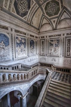 an ornately decorated room with stairs and paintings on the walls