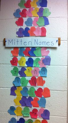 a bulletin board with hearts and letters written on it that spell out the name mitten names