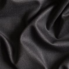 a close up view of the dark grey fabric that is covering it's surface