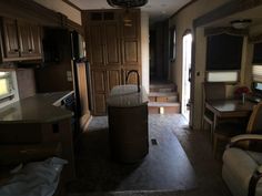 the inside of a travel trailer with kitchen and living room area in it's center