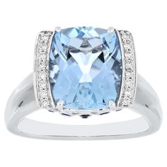 Elegant and exquisitely detailed 18 Karat White Gold Ring, center set with Aquamarine Cushion Sharp Corner 4.29Cts. Blue Sapphire Round 0.23Cts. Diamond Brilliant Round 0.16Cts Beautifully Hand crafted in 18 Karat White Gold. Stone Detail: Aquamarine Cushion Sharp Corner : 12X10 MM Blue Sapphire Round : 1.00 MM 1.10 MM 1.25 MM 1.50 MM Stone Weight: Aquamarine Cushion Sharp Corner : 4.29 Blue Sapphire : 0.23 Diamond: GH/SI Diamond Size - 1.25 mm Total Diamond Weight: 0.16 Luxury Aquamarine Jewelry In Diamond White, Luxury Light Blue Aquamarine Diamond Ring, Luxury Light Blue Aquamarine Rings, Luxury Aquamarine Octagon Ring, Luxury Aquamarine Emerald-cut Rings, Blue Sapphire Diamond Ring, Blue Sapphire Diamond, Aquamarine Blue, White Gold Ring