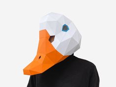 a person wearing an orange and white paper duck mask on their face, with one eye open